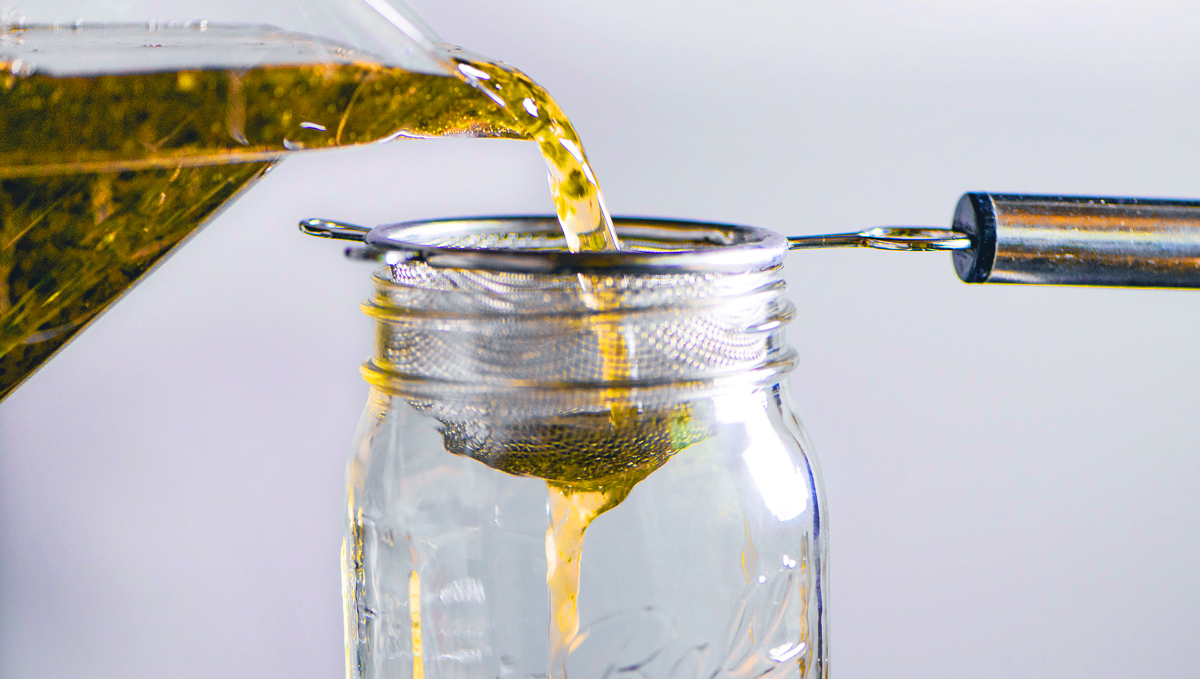 Straining the cannabis buds out.