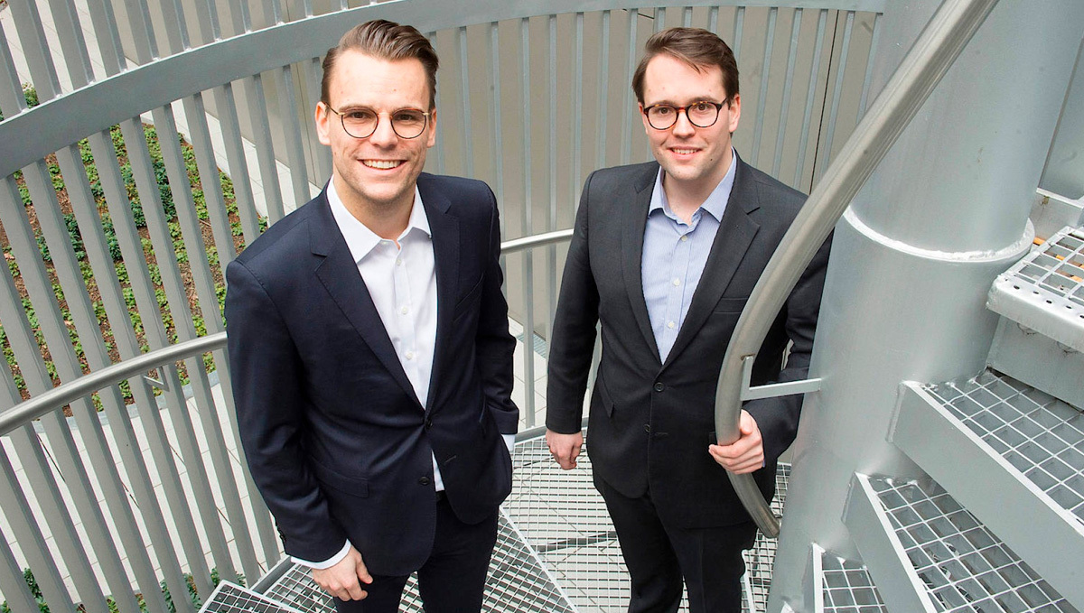 Snoop Dogg Invests in a German Weed Startup, Betting on Imminent Legalization: Brothers Sons, wearing suits and posing on a winding stairs