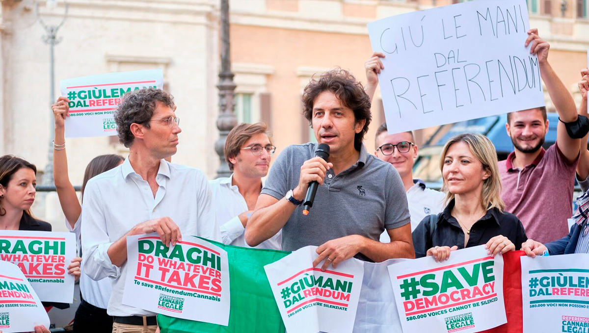 Italy: Court Stalls Referendum to Legalize Weed Growing. Protesters holding signs in favor of protecting democracy Italy: Court Stalls Referendum to Legalize Weed Growing. Protesters holding signs in favor of protecting democracy