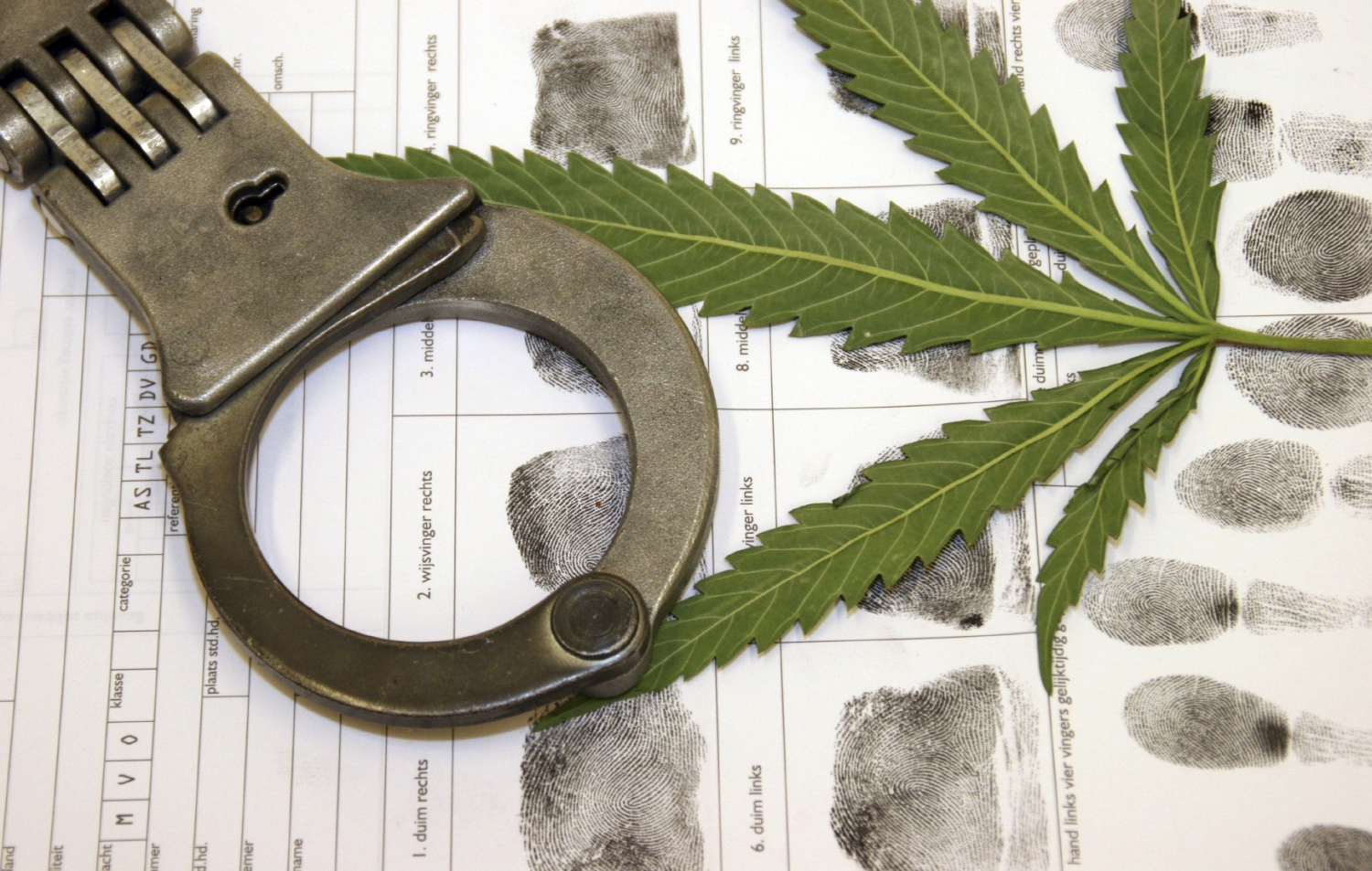 Biden Proposes Sweeping Marijuana Reform: A collage of handcuffs and a cannabis leaf