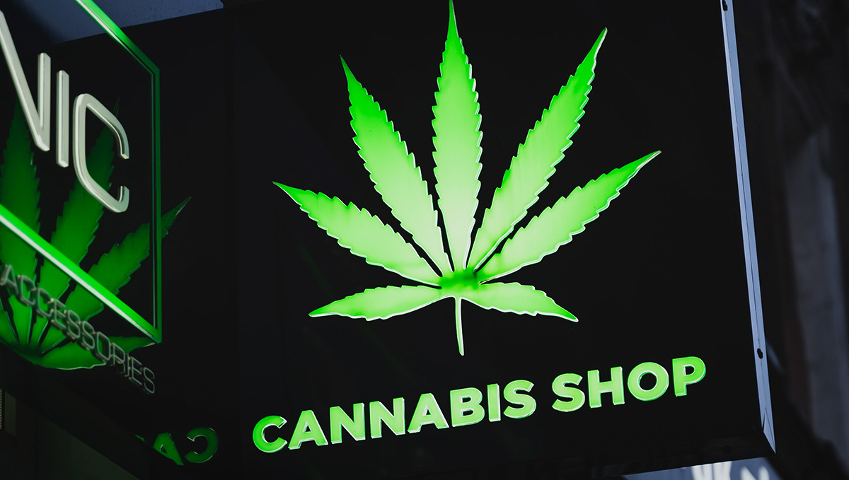 Canada to Allow Marijuana Sales at Airports: A dark-colored cannabis shop sign with a weed leaf logo