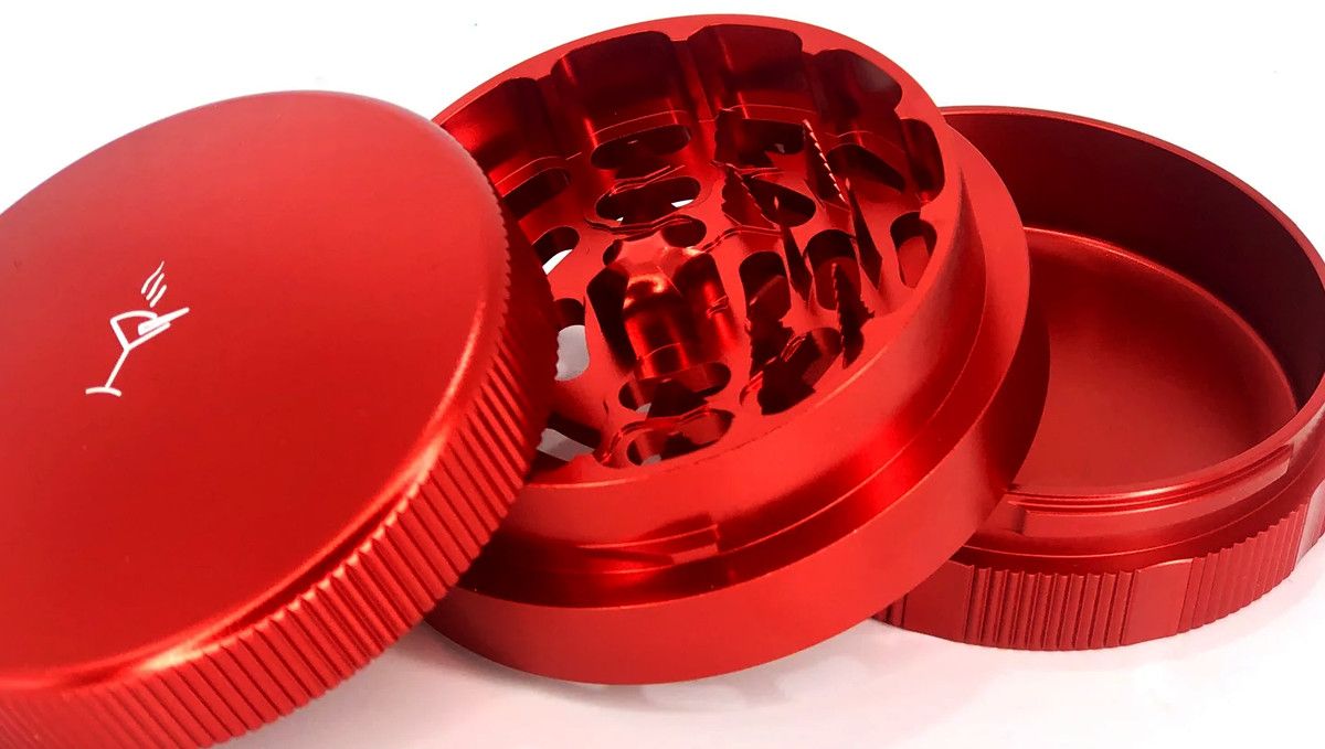 15 Best Weed Grinders to Buy in 2022: A closeup of a bright-red three-piece TumbleWeed device