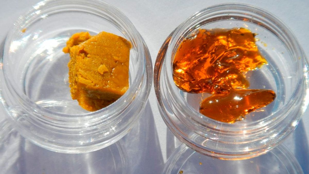 Cannabis Shatter: What Is It, How To Make And Smoke THC & CBD Hash Oil: Two glass vials on a table top, one with wax, the other with shatter